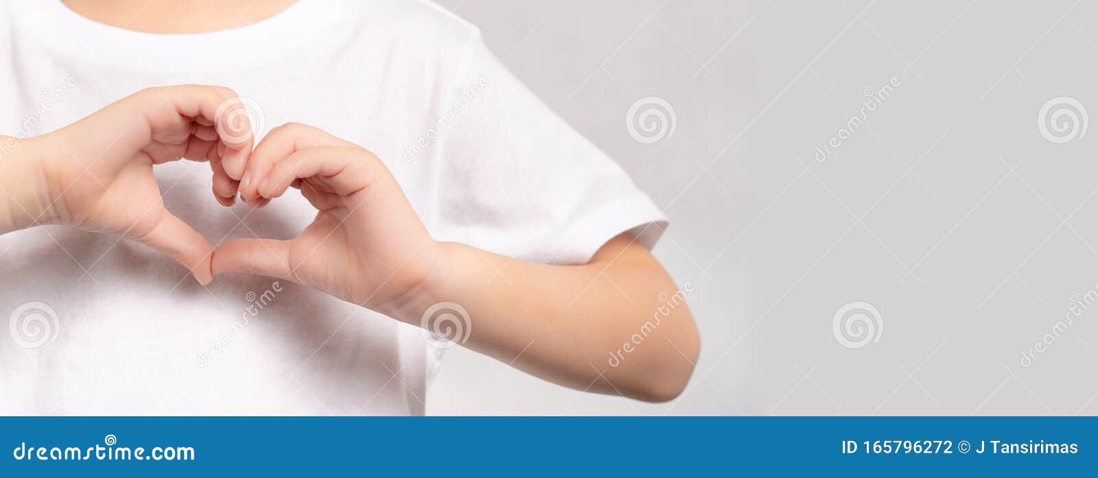 an adorable little child`s hands gesture in heart  showing love and kindness. concept of health care, charity, organ donatio
