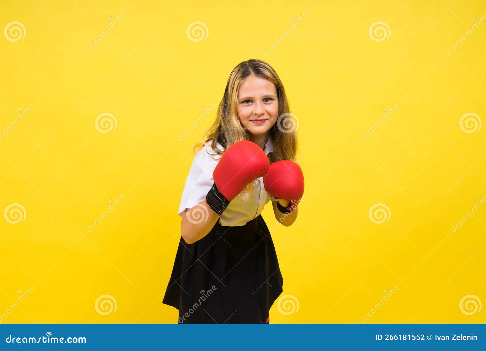 Adorable Little Girl Boxer Practicing Punches in Studio Stock Photo