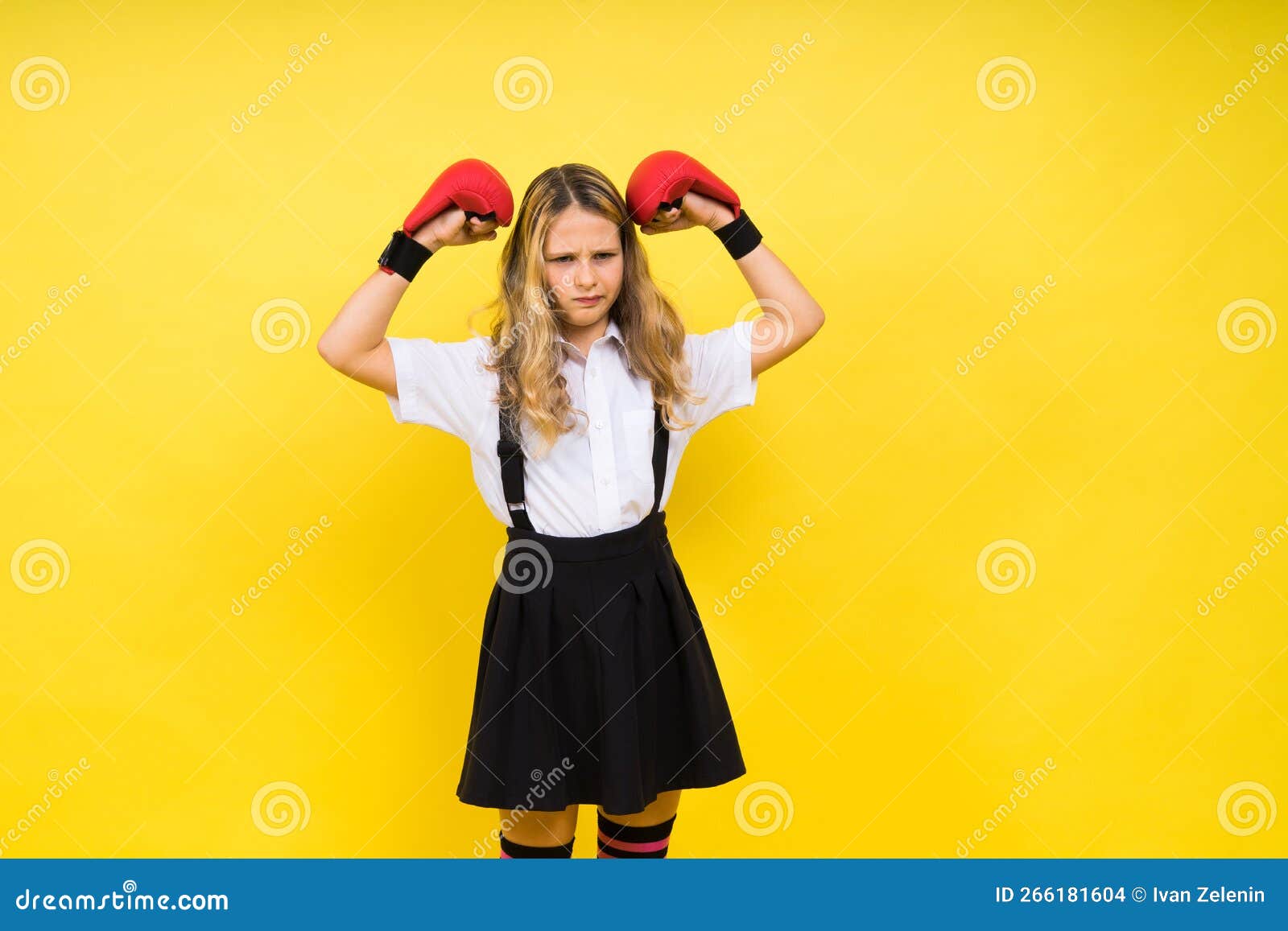 Adorable Little Girl Boxer Practicing Punches in Studio Stock Photo