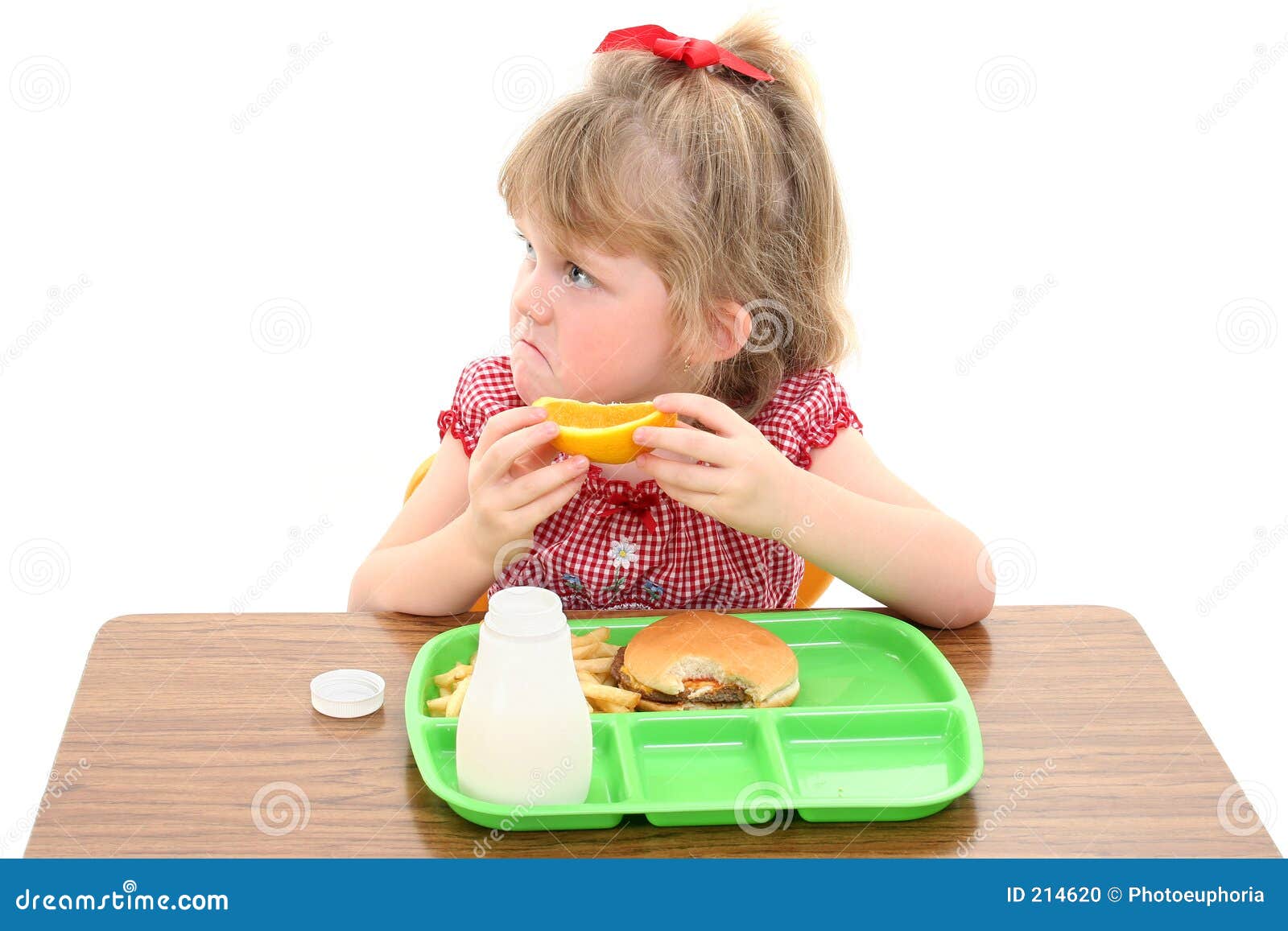 adorable little girl unhappy with school lunch