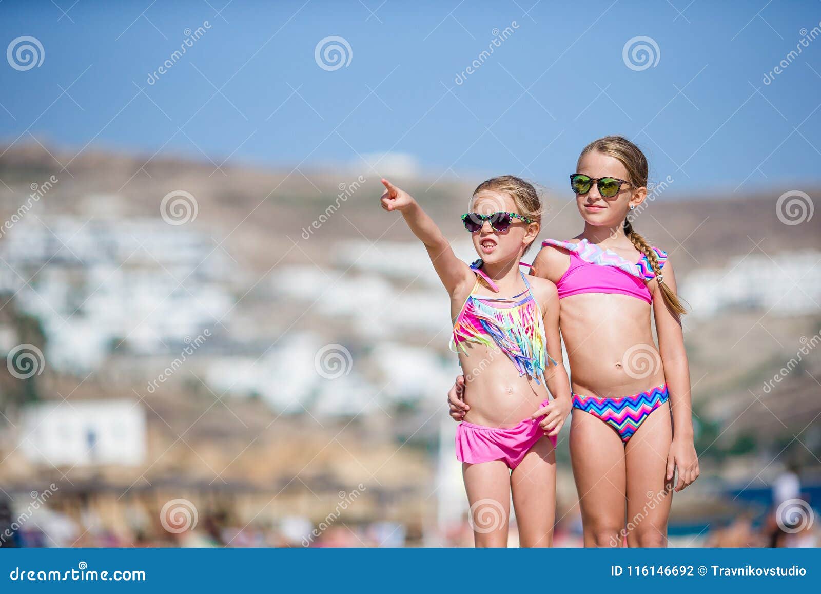 adorable little girls having fun during beach vacation.