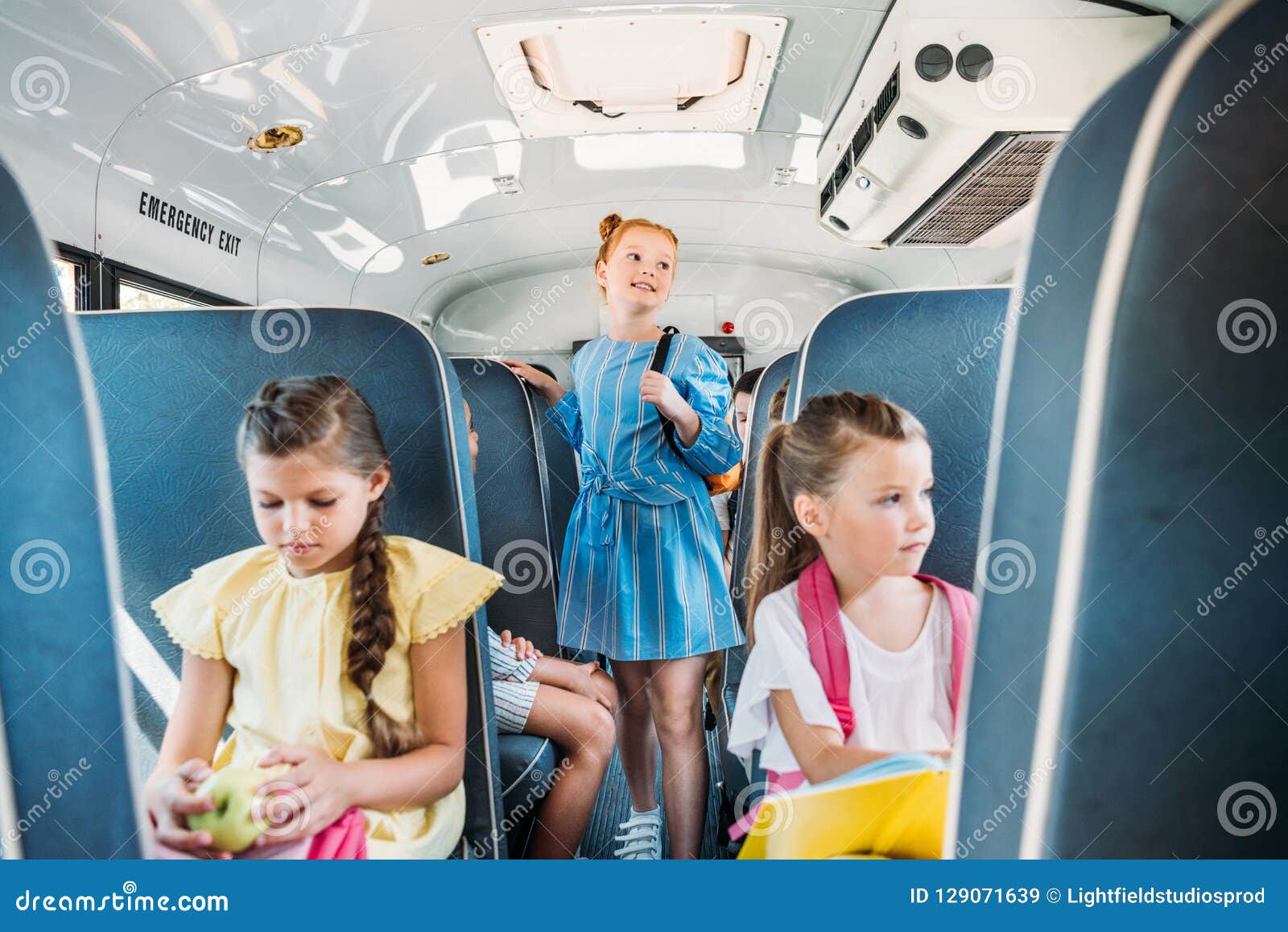 adorable little scholars riding on school bus