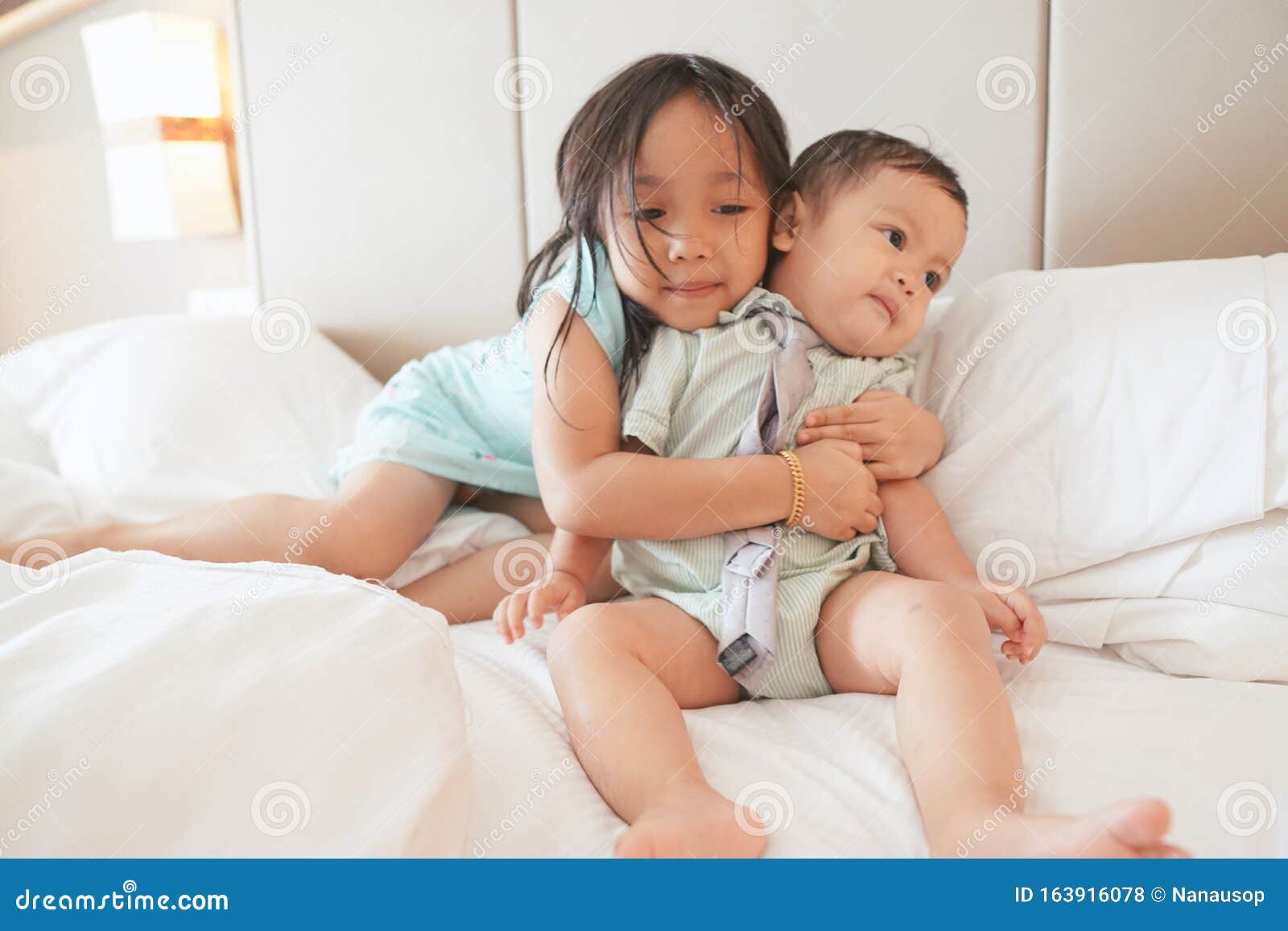 Asian Siblings on a White Bed Stock Photo - Image of moment, neckties ...