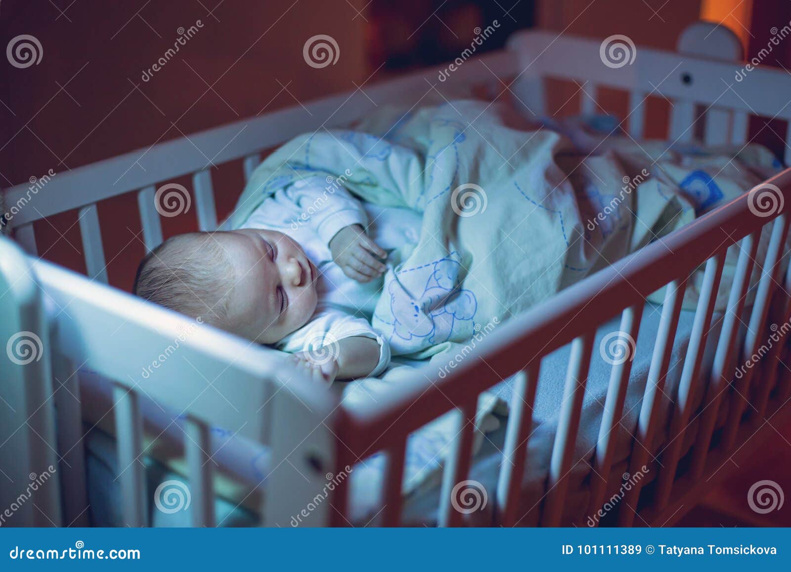 Adorable Newborn Baby Boy Sleeping In Crib At Night Stock Image