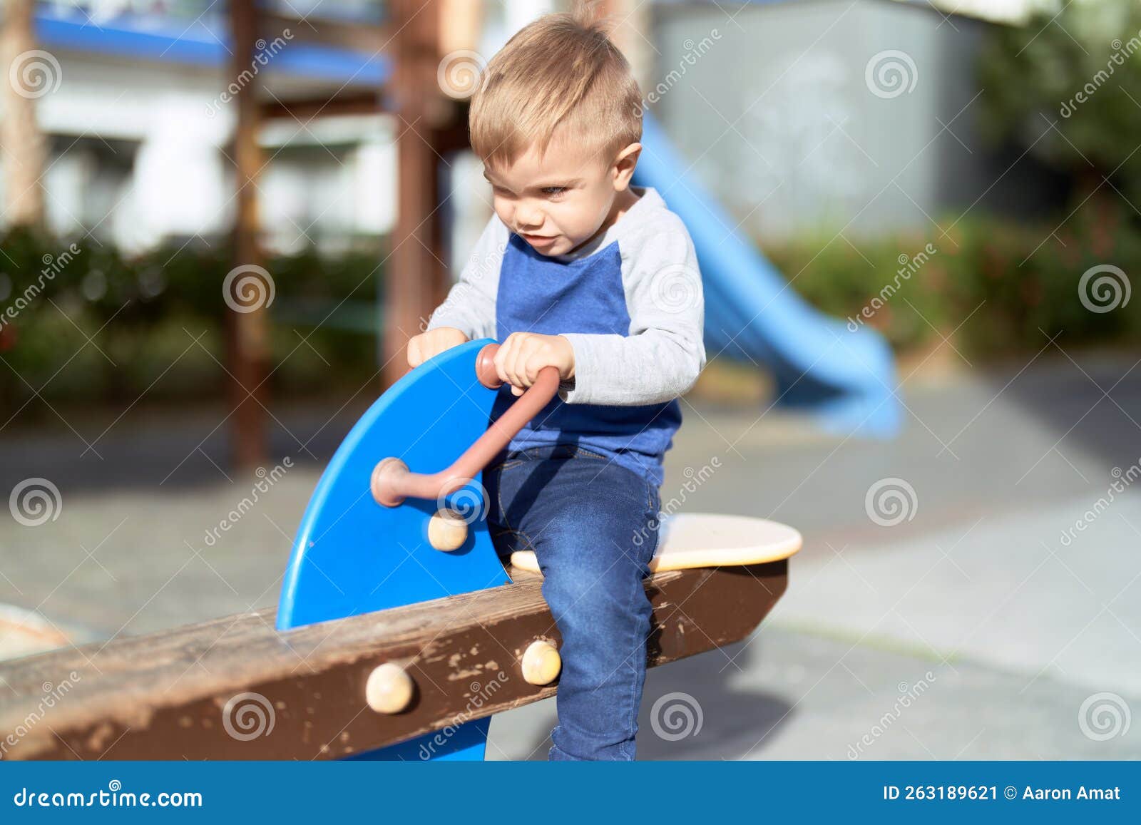 Adorable Toddler Playing on Swing at Park Playground Stock Image