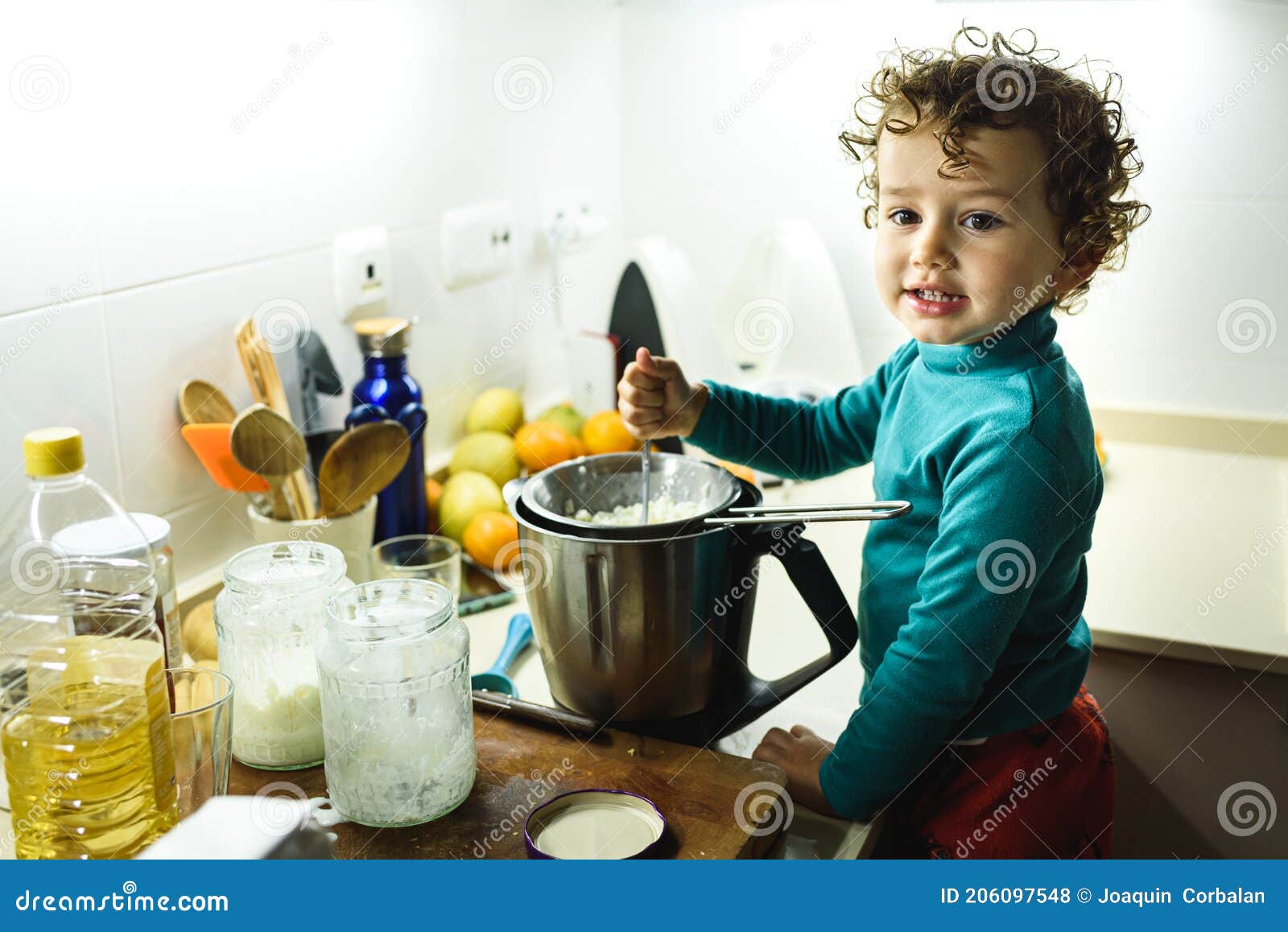 Adorable 2 Year Old Girl Cooking a Cake at Home Overnight Stock Photo