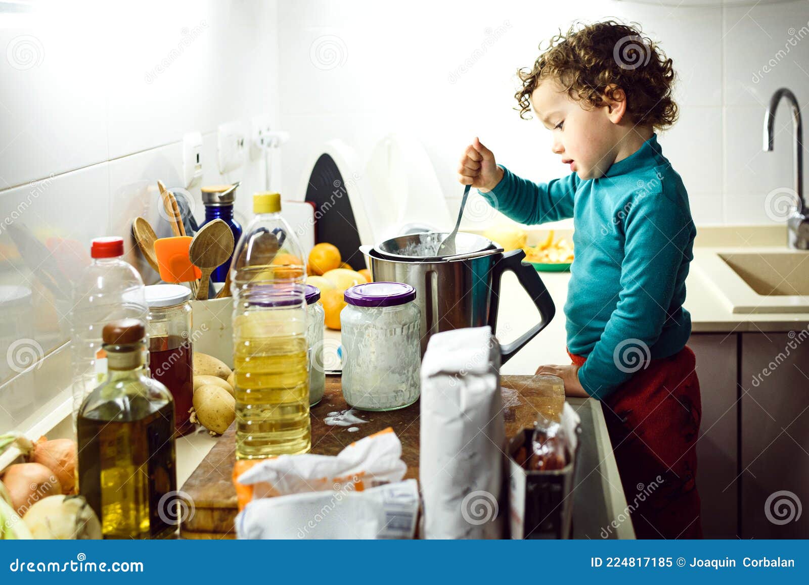Adorable 2 Year Old Girl Cooking a Cake at Home Overnight Stock Image