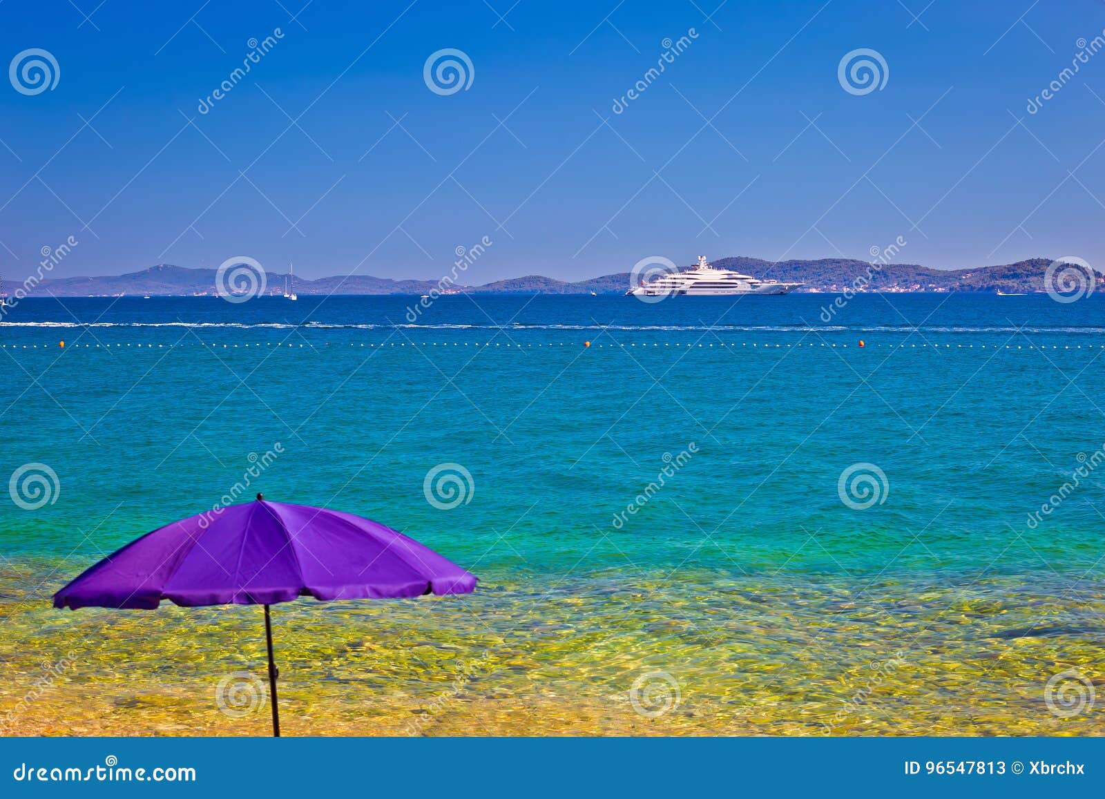 adriatic beach in zadar with megayacht background