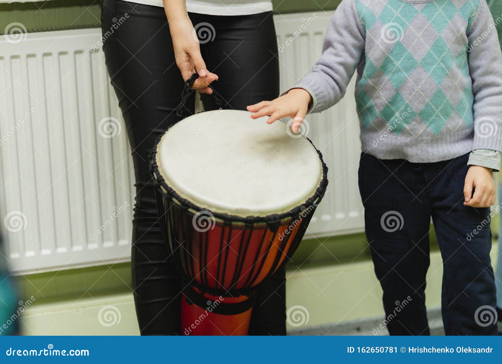An Adult and a Child are Playing a Musical Instrument. African Djembe Meinl  Stock Image - Image of culture, equipment: 162650781