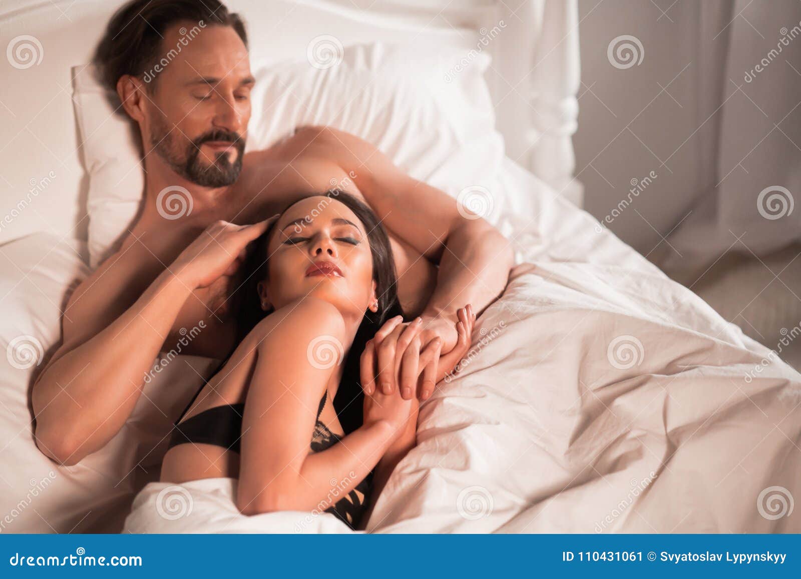 Young Love Couple In Bed Romantic Scene In Bedroom Stock