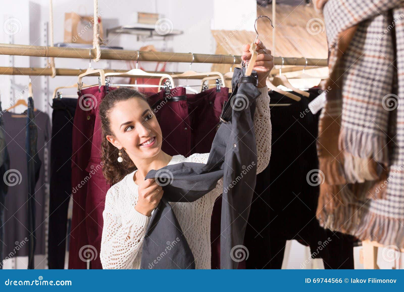 Adult Female Brunette Choosing Trousers in Shop Stock Photo - Image of ...