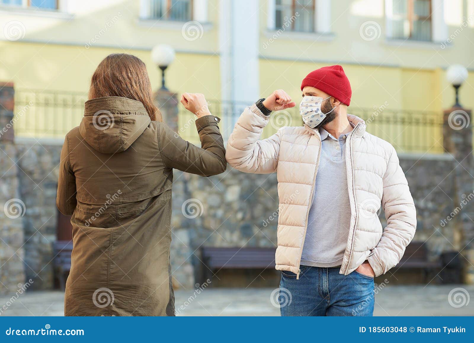 Adult Friends in Face Masks Bump Elbows instead of Greeting with a ...