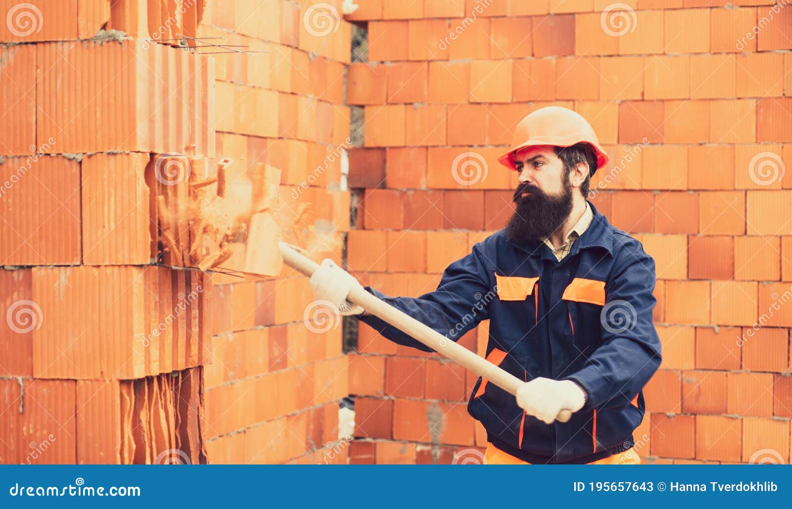 Adult Handsome Worker Builder Using Hammer and Smash Tool at