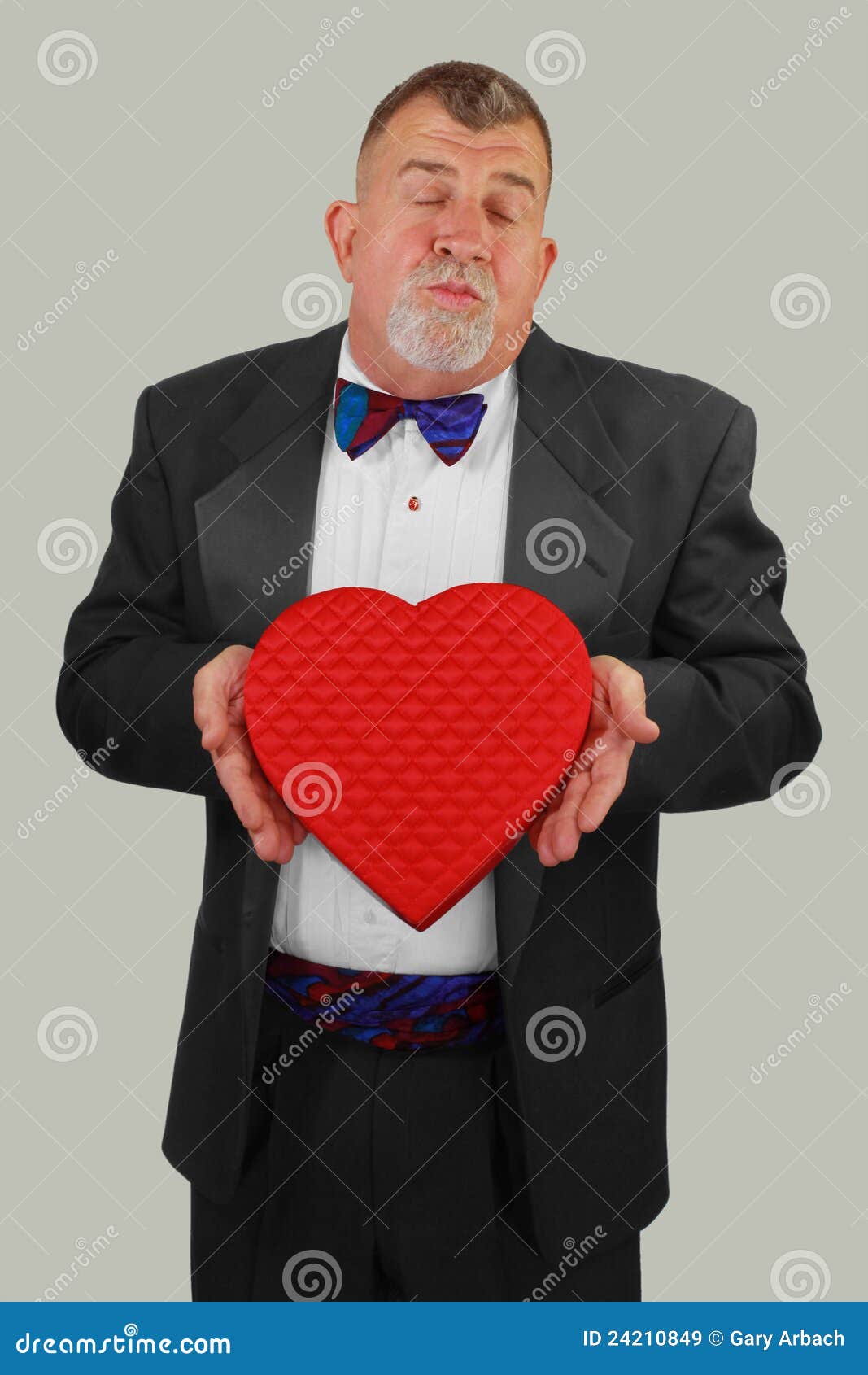 adult man offering valentine's day kiss and candy