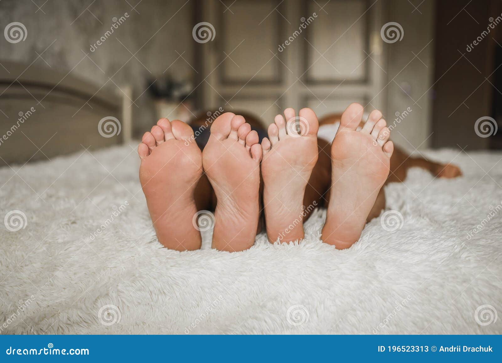 Adult Man And A Woman With Bare Feet Are Lying On The Bed Stock Image Image Of Beautiful Friends 196523313