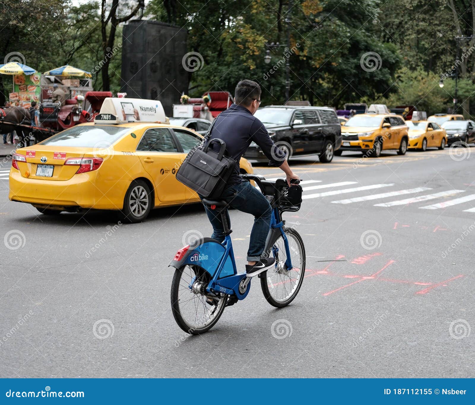 Adult Member Of The Public Seen Riding A Bicycle Beside A Moving New York Taxi Editorial Image