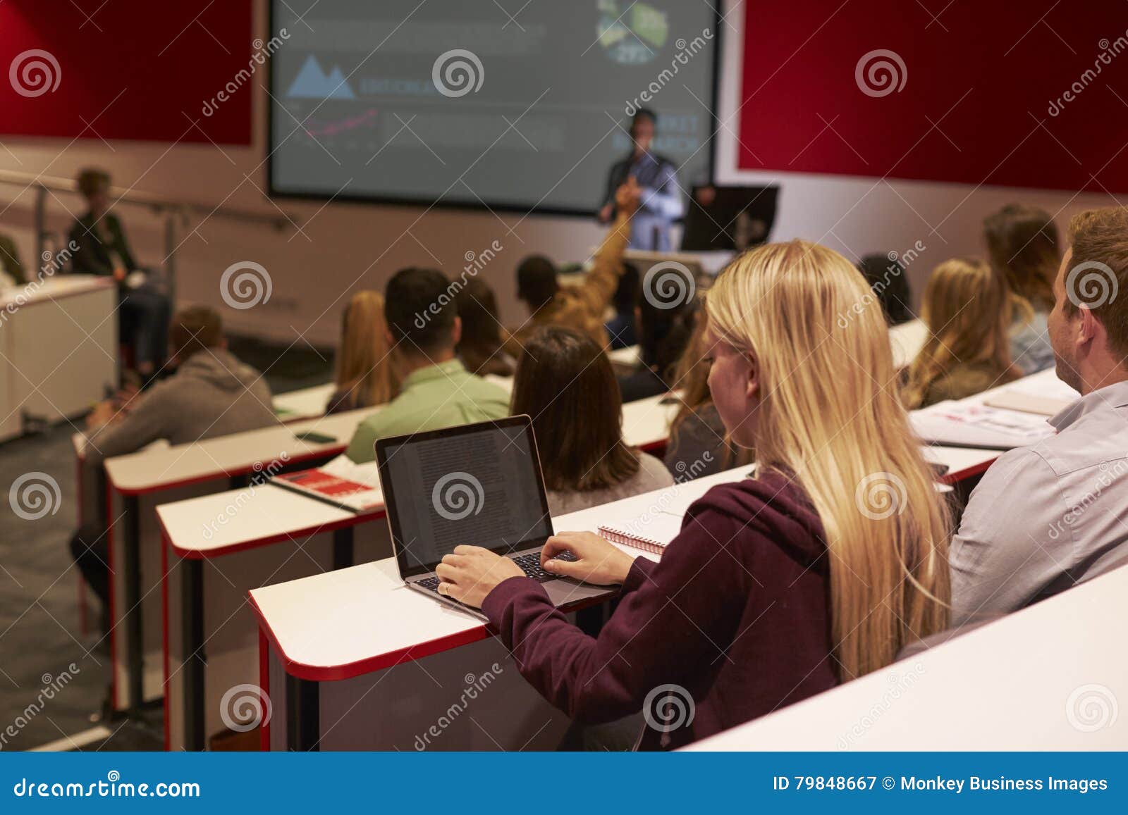 adult student using laptop computer at a university lecture