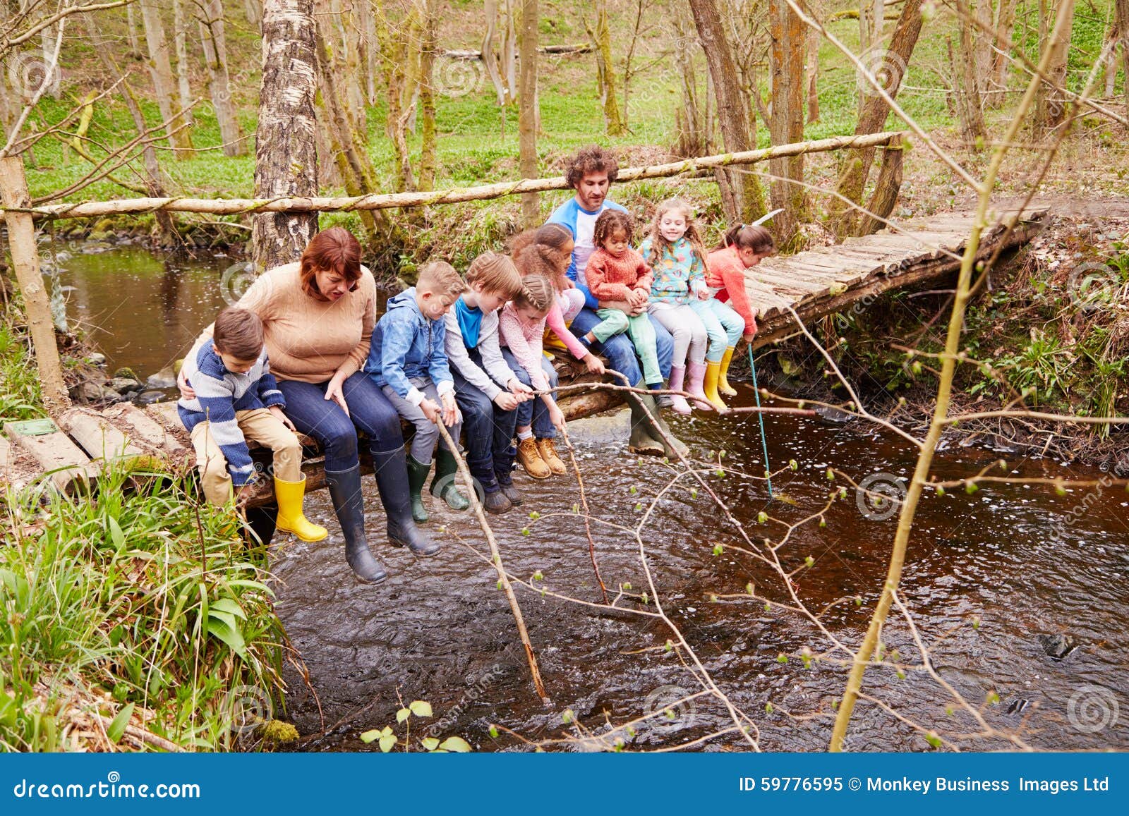 Adults with Children on Bridge at Outdoor Activity Centre Stock Image