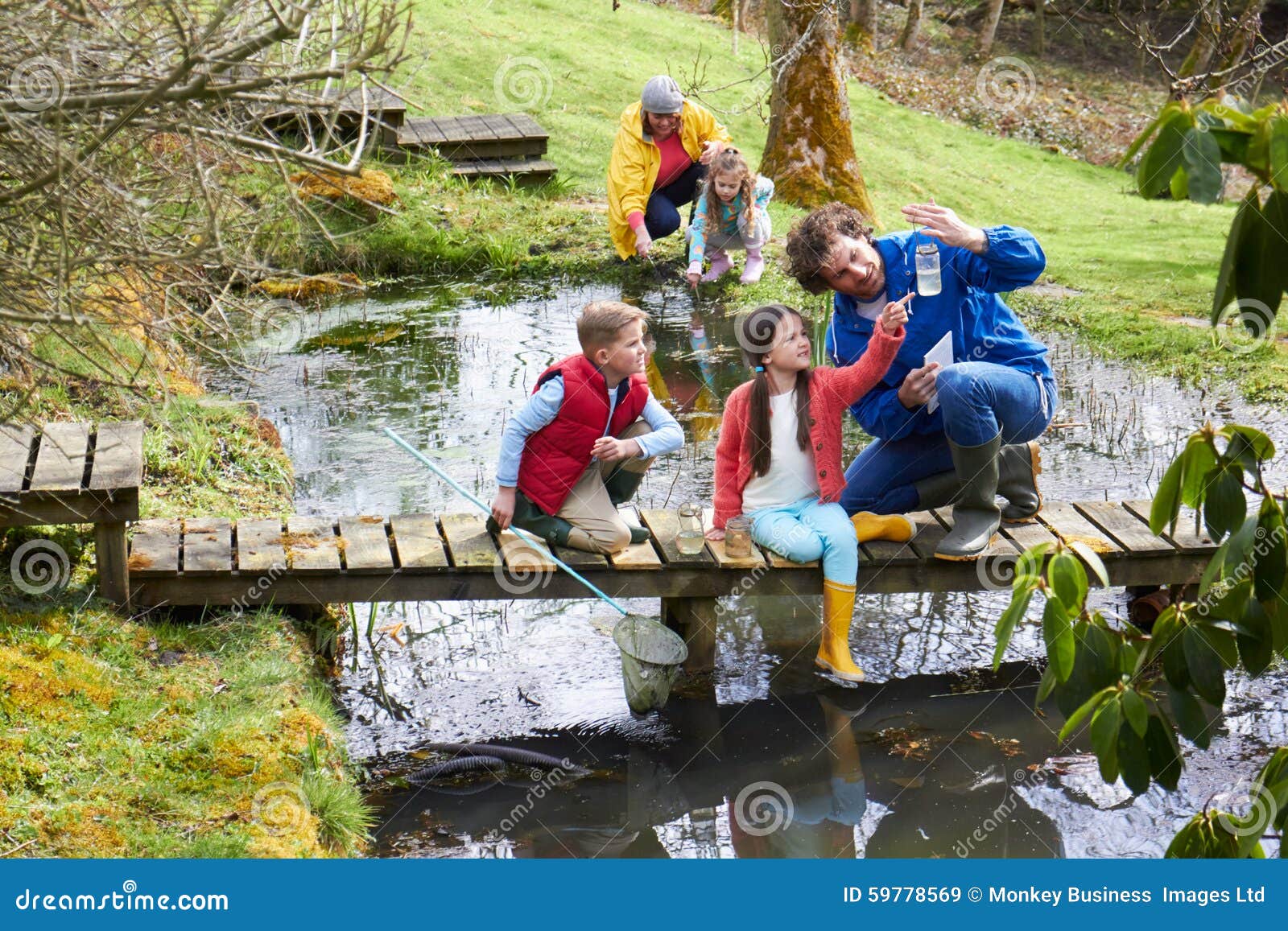 Adults with Children on Bridge at Outdoor Activity Centre Stock Image