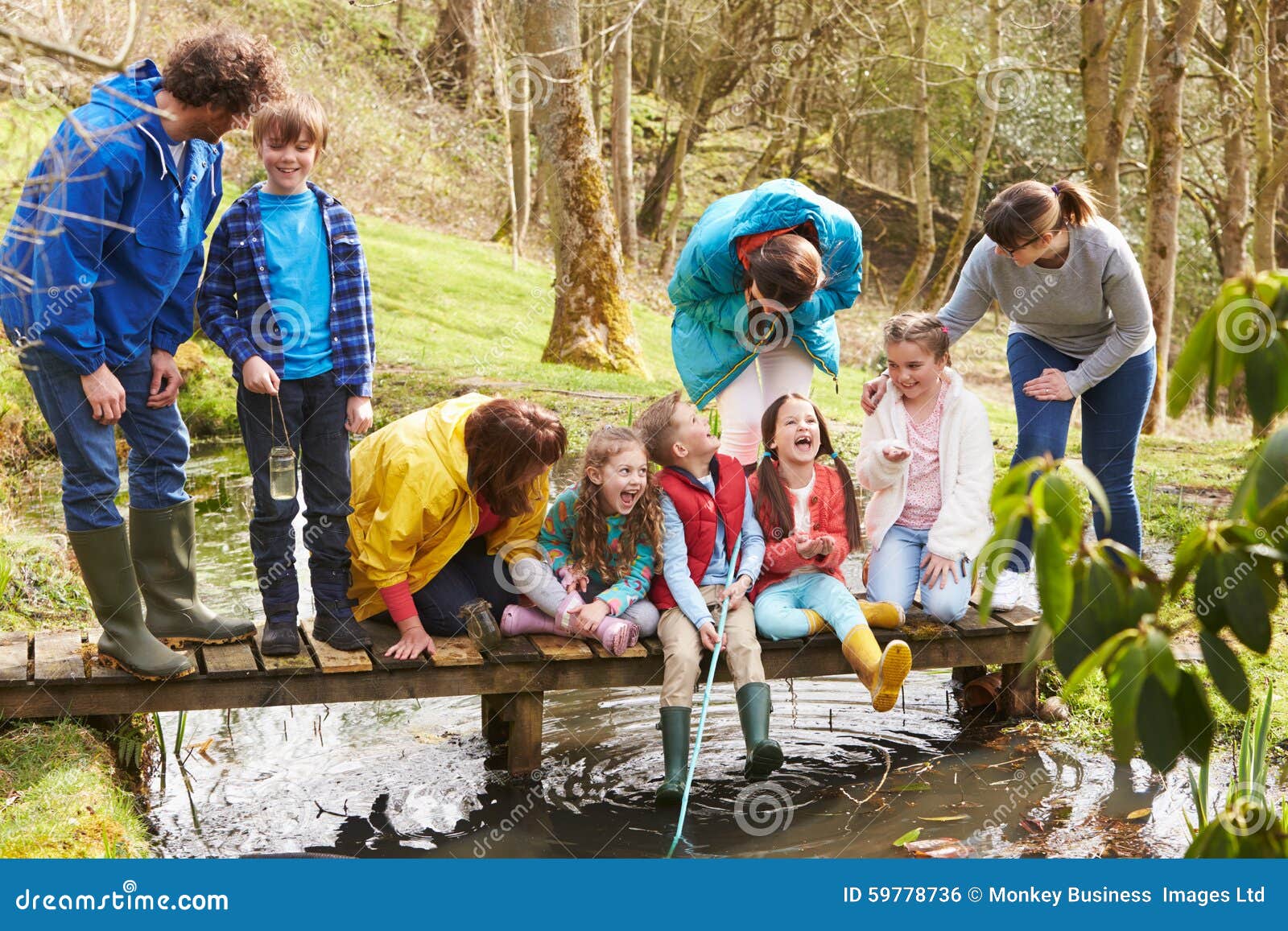 adults with children on bridge at outdoor activity centre