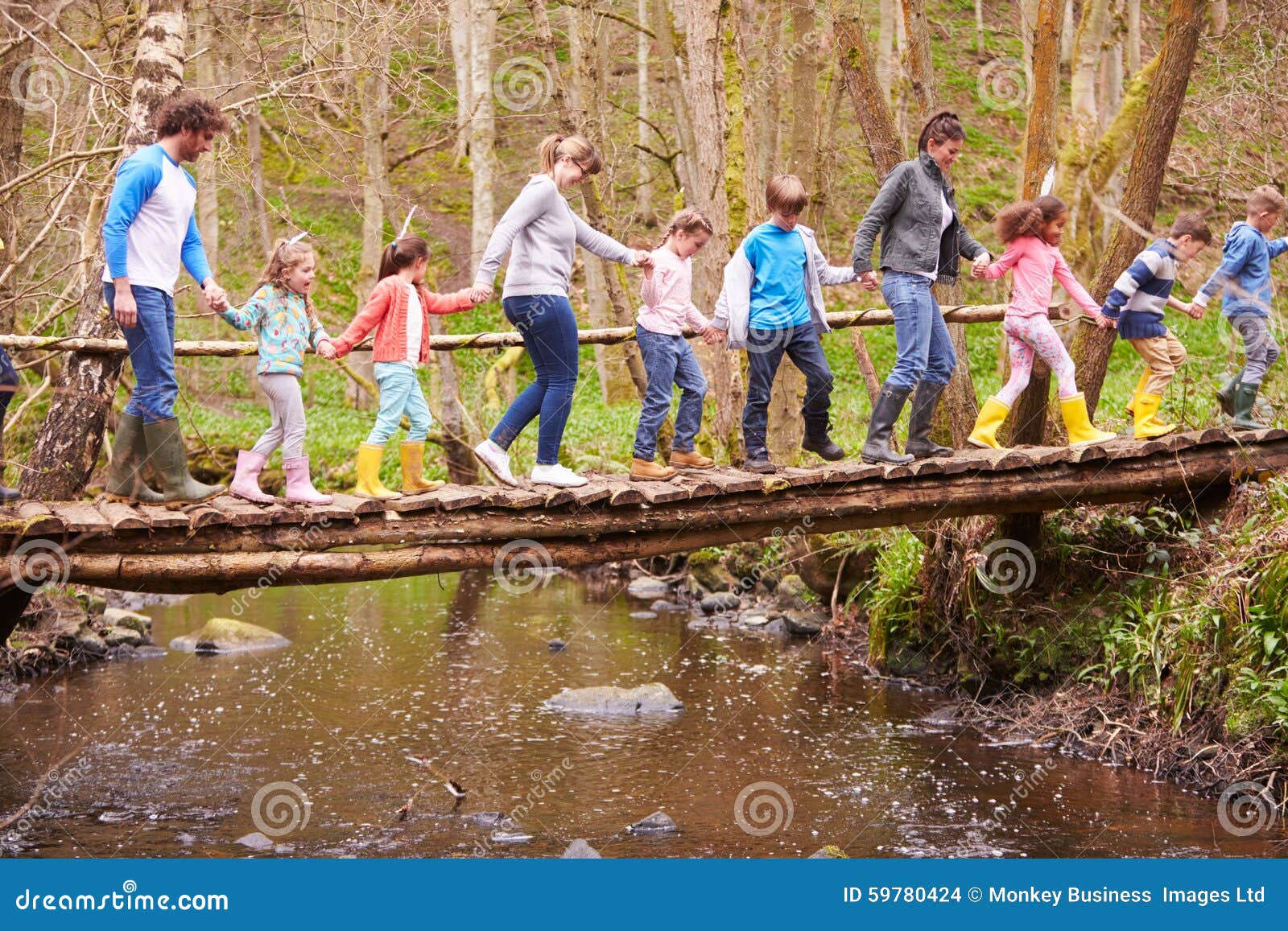 adults with children on bridge at outdoor activity centre