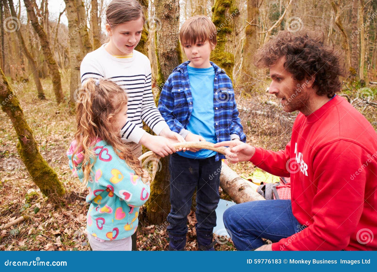 Adults and Children Examining Animal Horn at Activity Centre Stock