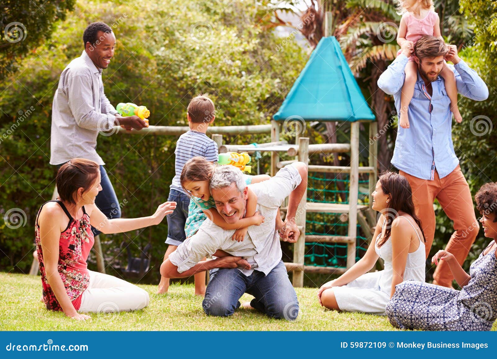 adults and kids having fun playing in a garden