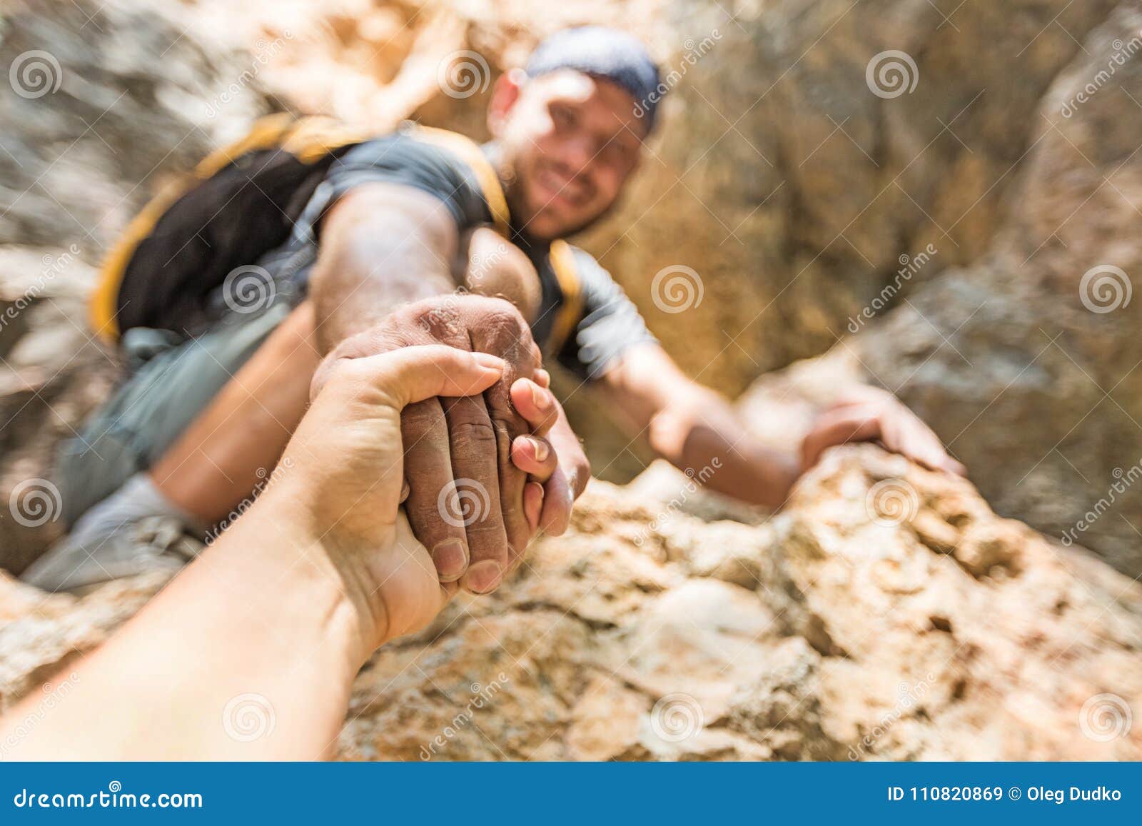 adventurers helping each other to climb the