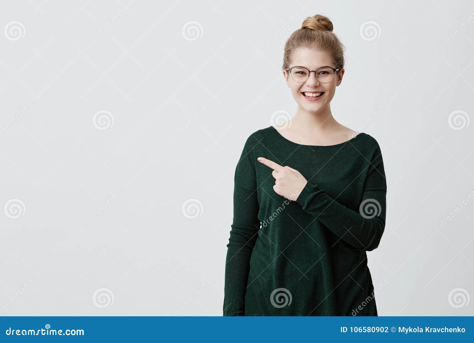 advertisment concept. young lady with blonde hair, stylish eyewear in green sweater and mirthful expression