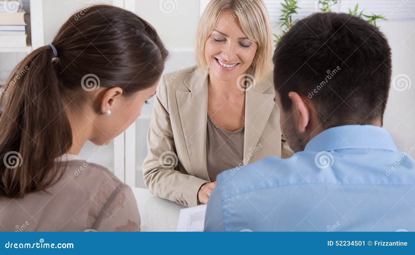 adviser, broker and customers sitting at desk in the office.