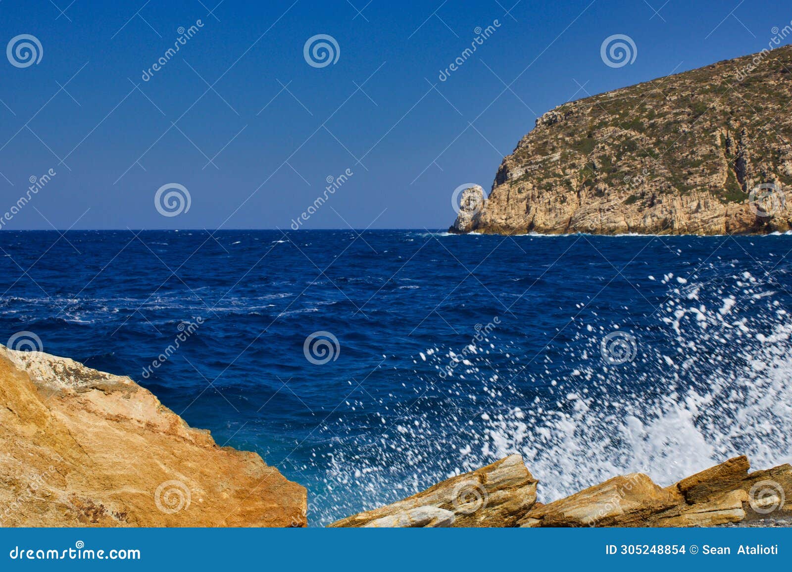 aeagean sea waves crashing on the rocks of zeus bay, naxos, greece