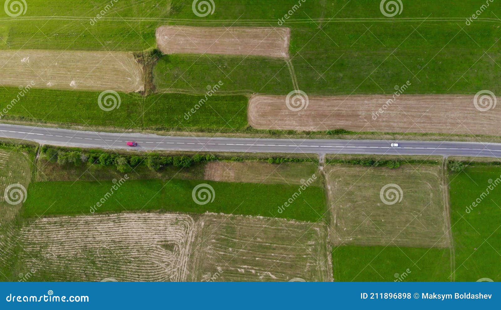 Aerial Drone Footage, Two Cars Driving on the Road between the Fields Stock Photo Image of