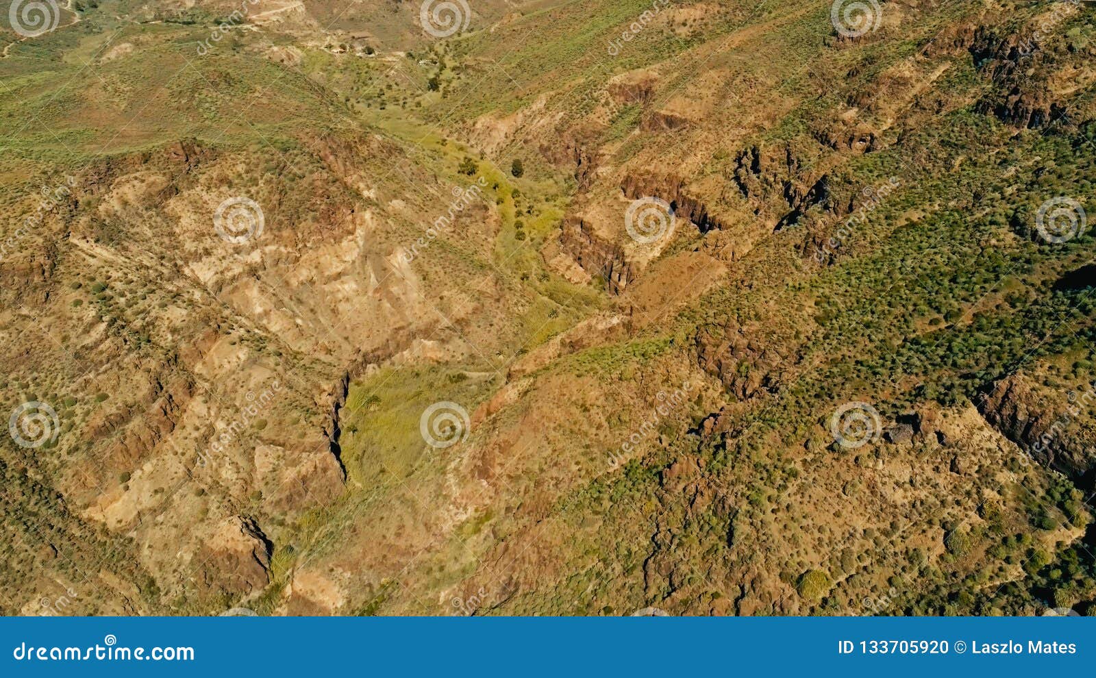 aerial drone image of beautiful stunning landscape view off the degollada de la yegua viewpoint with a valley with palm trees on a