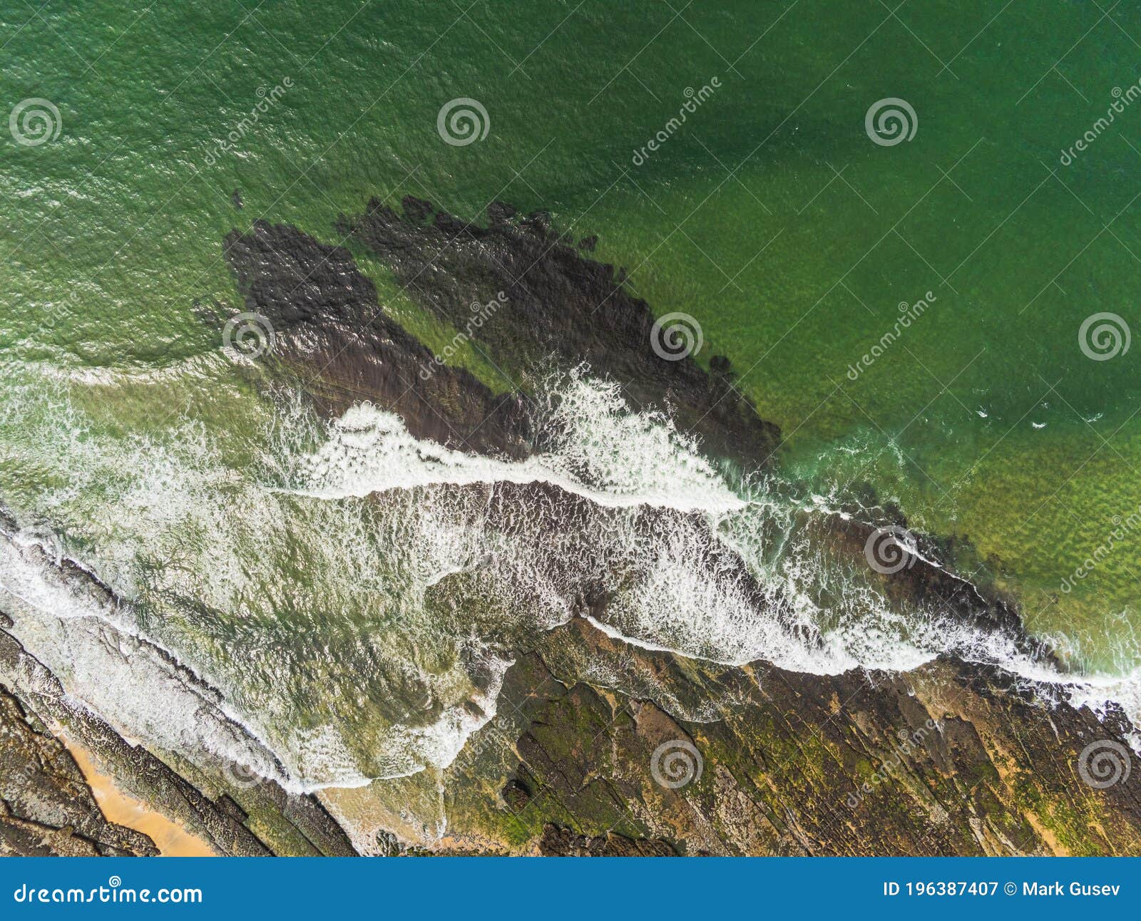 aerial drone view on fanore beach, county clare, ireland. top down view, stone rock coast line and ocean waves