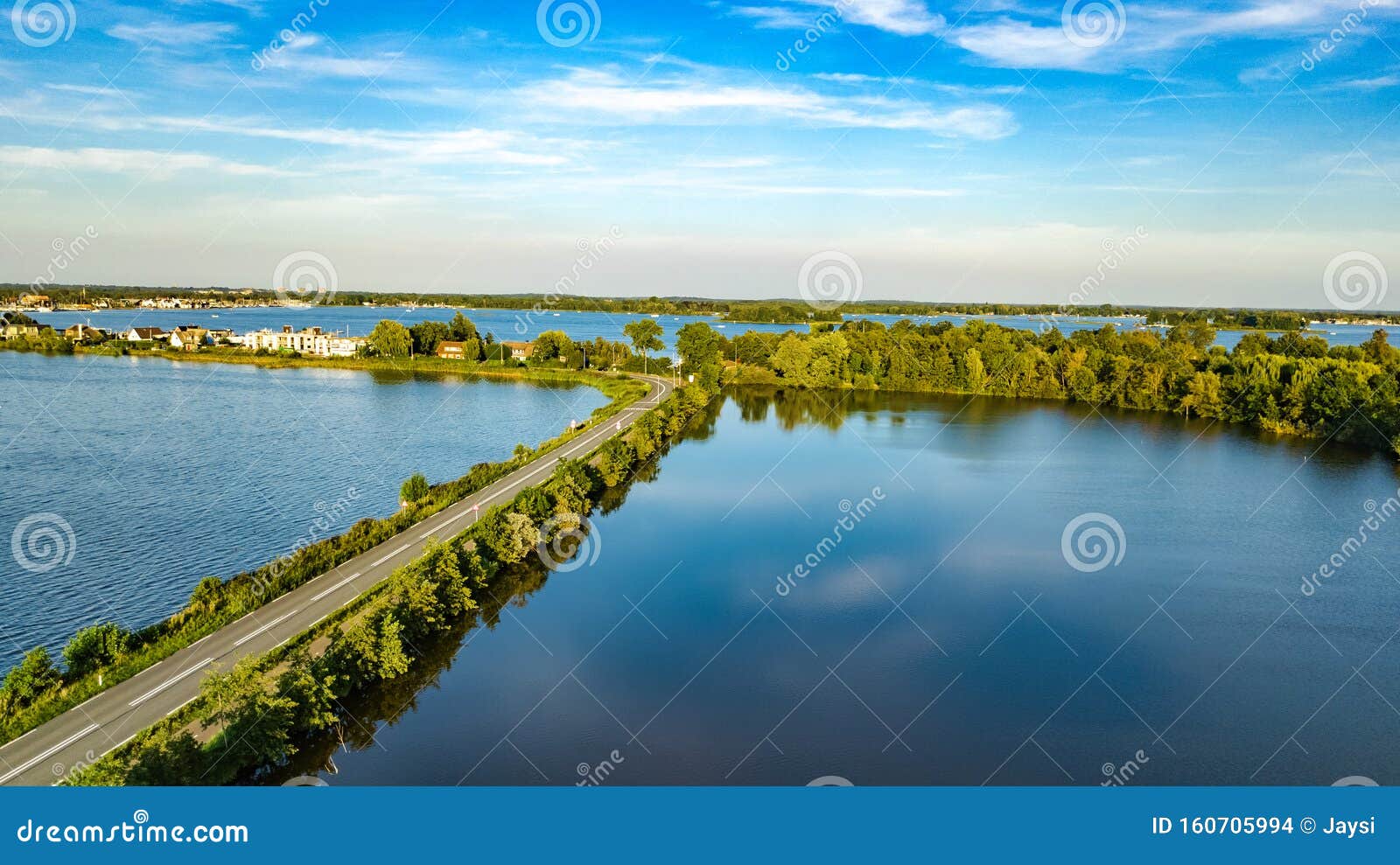 aerial drone view of motorway road and cycling path on polder dam, cars traffic, north holland, netherlands