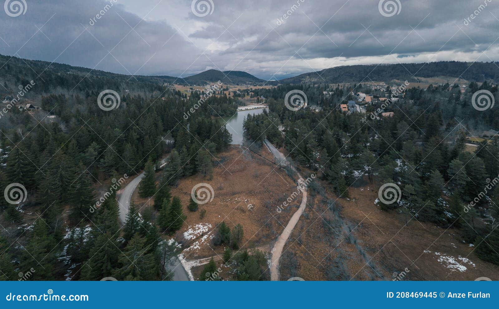 aerial drone view of rakitna lake in central slovenia, famous for its lake and marshes in the middle of the winter on a cloudy day
