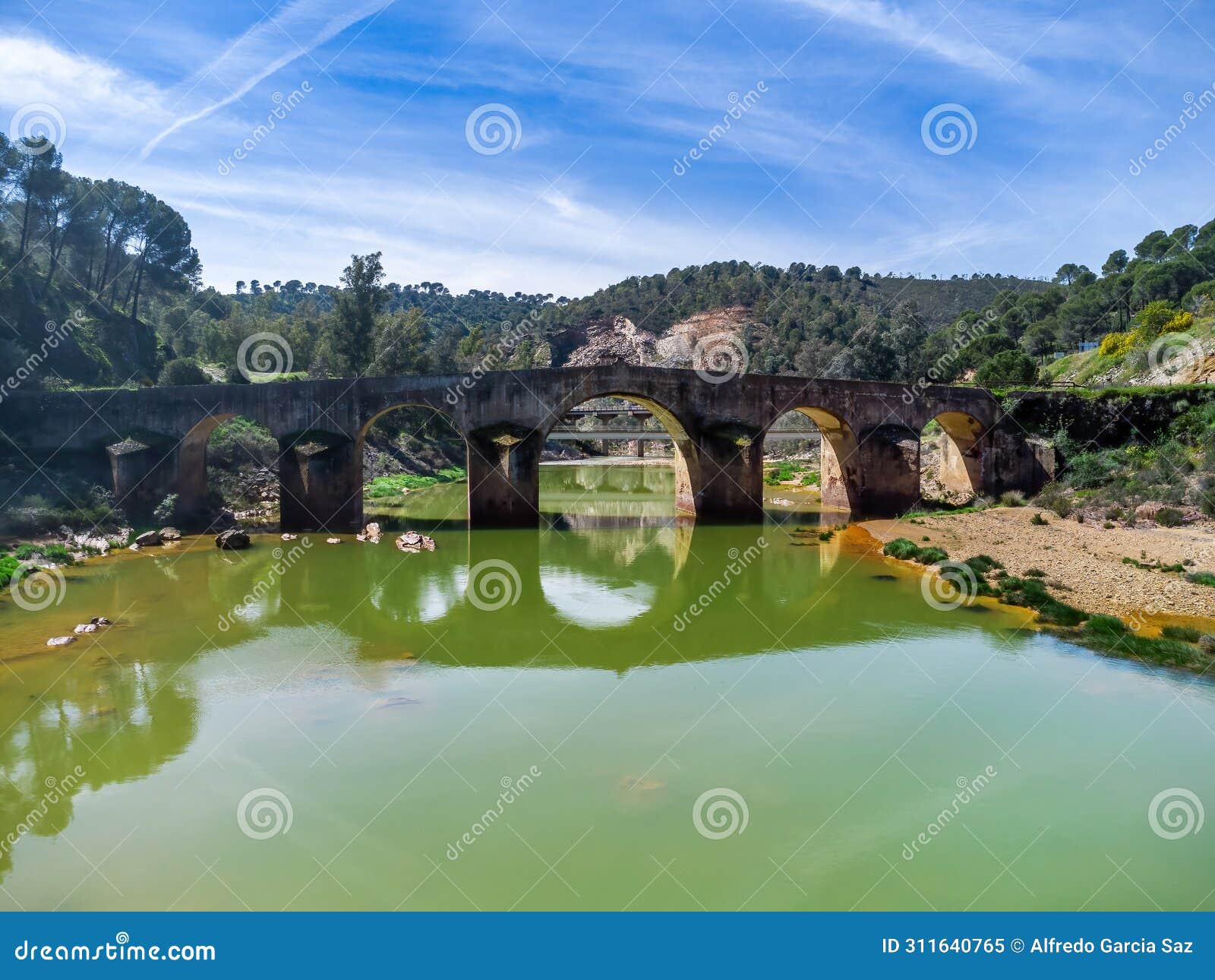aerial drone view of roman bridge in the hiking route of the water mills along the odiel river from sotiel coronada