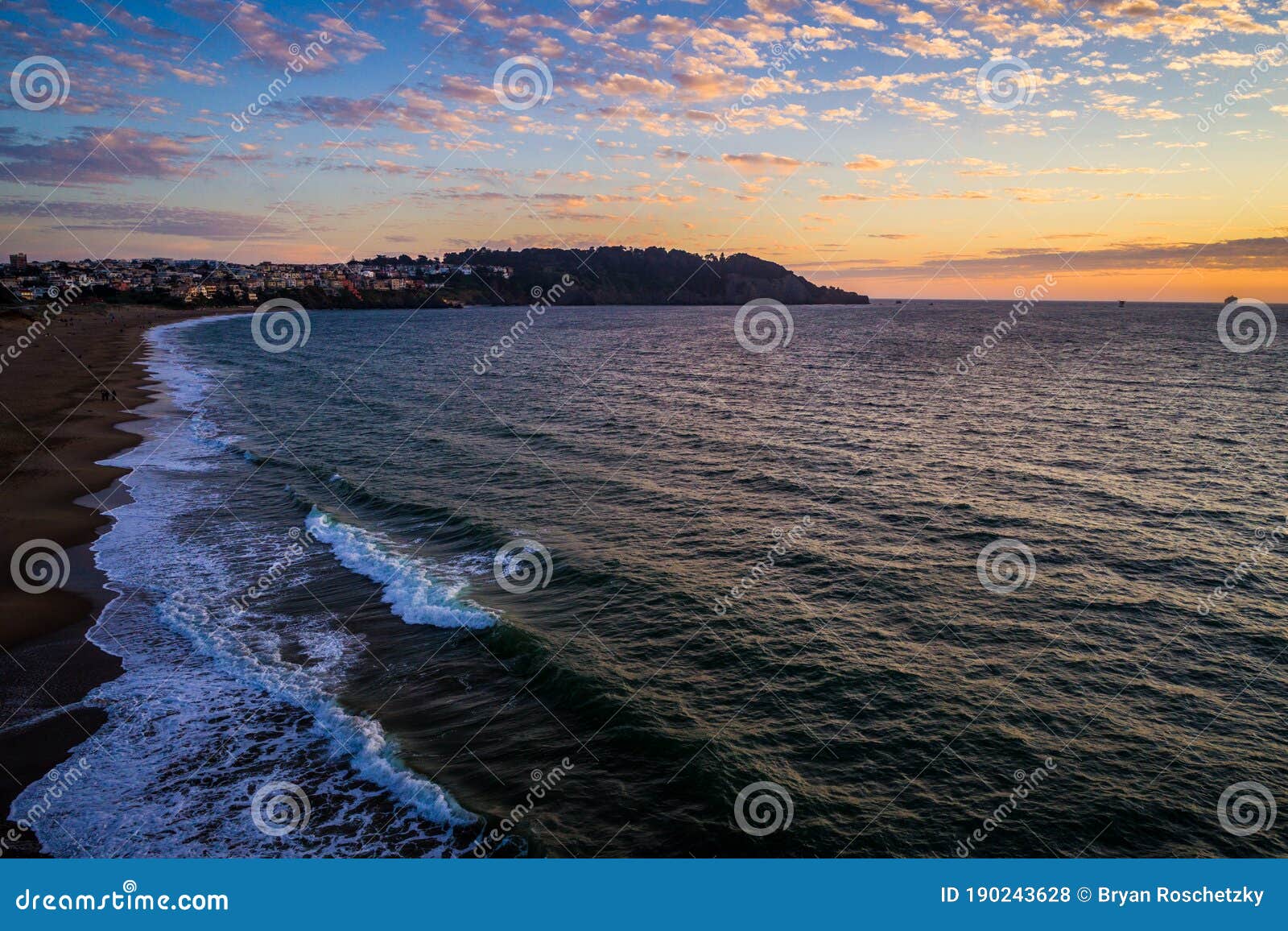 aerial drone views at sunset over bay area of san francisco california at houses and mansions extending out into the coast