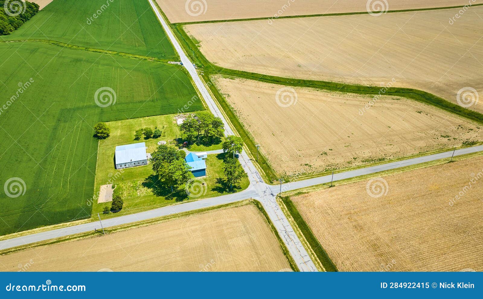 Aerial Farm House on Corner of Intersection with Green Field and Three