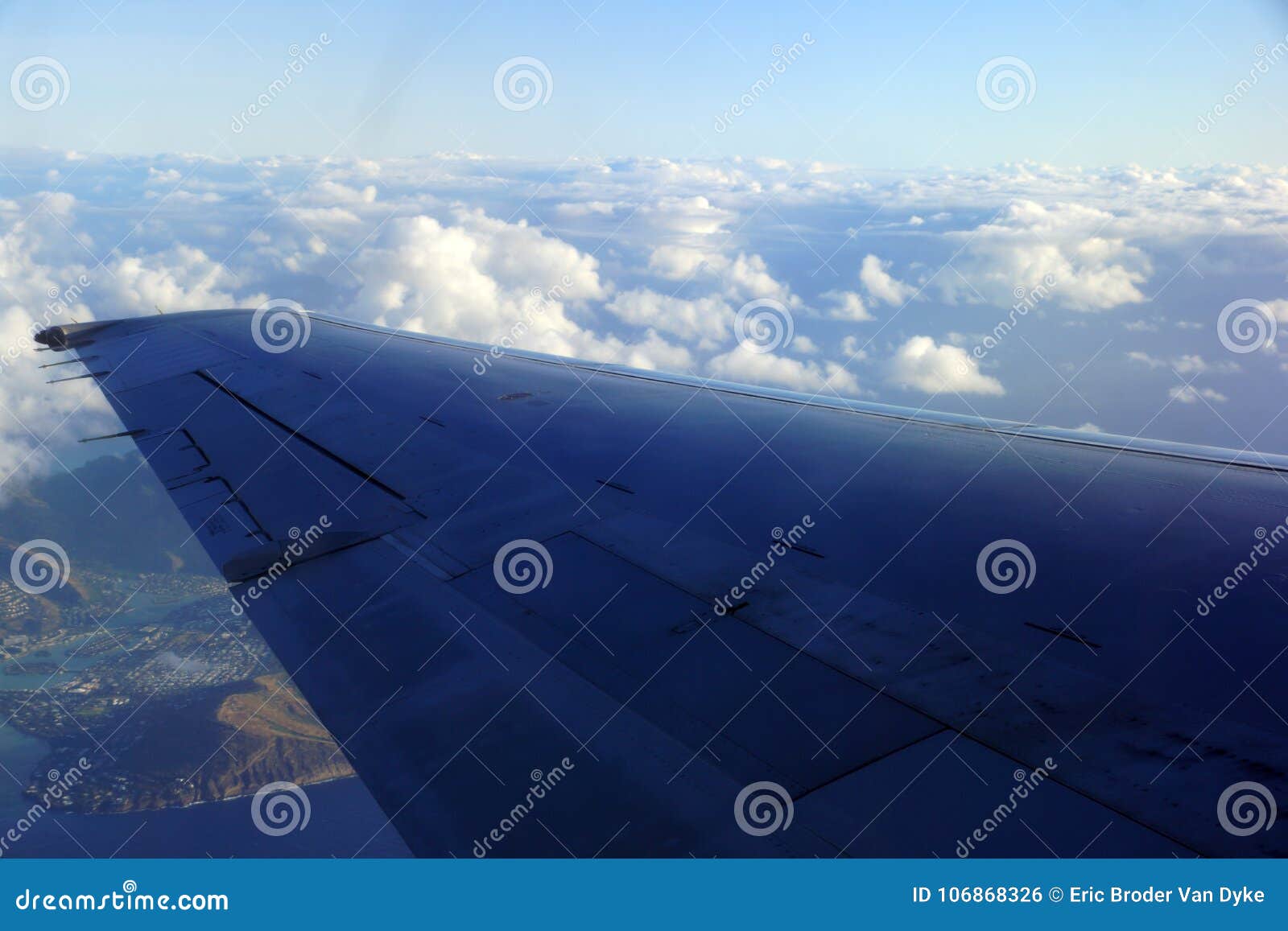 aerial high in the sky shot of window view of plane leaving honolulu