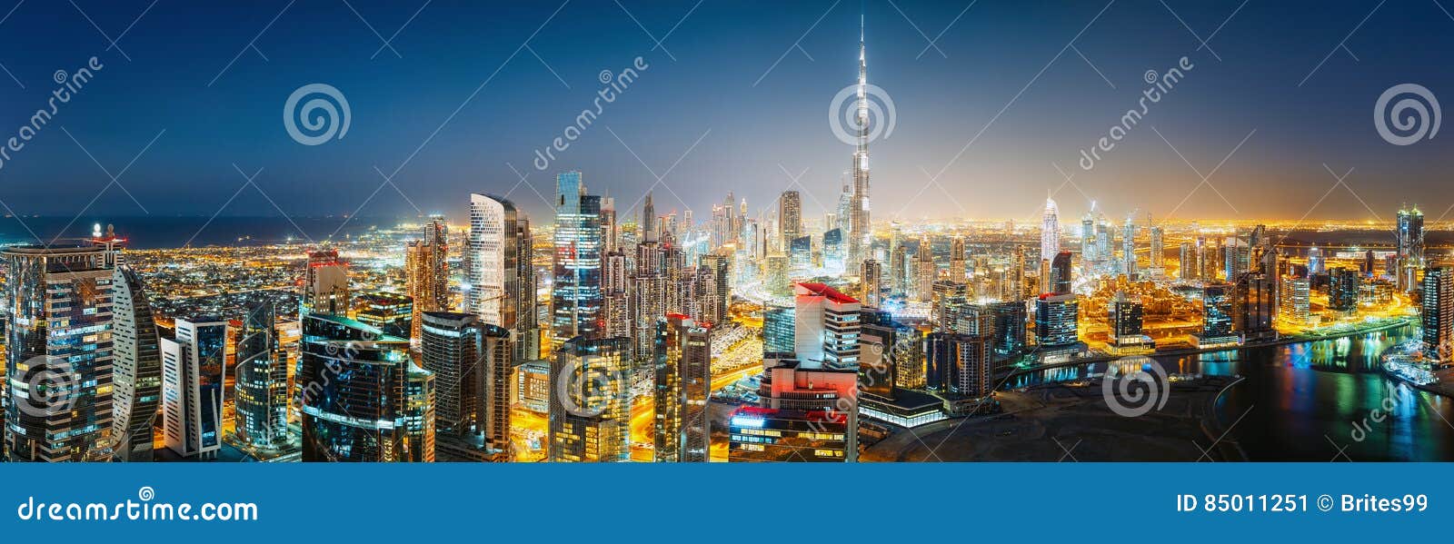 aerial panoramic view of a big futuristic city by night. business bay, dubai, uae.