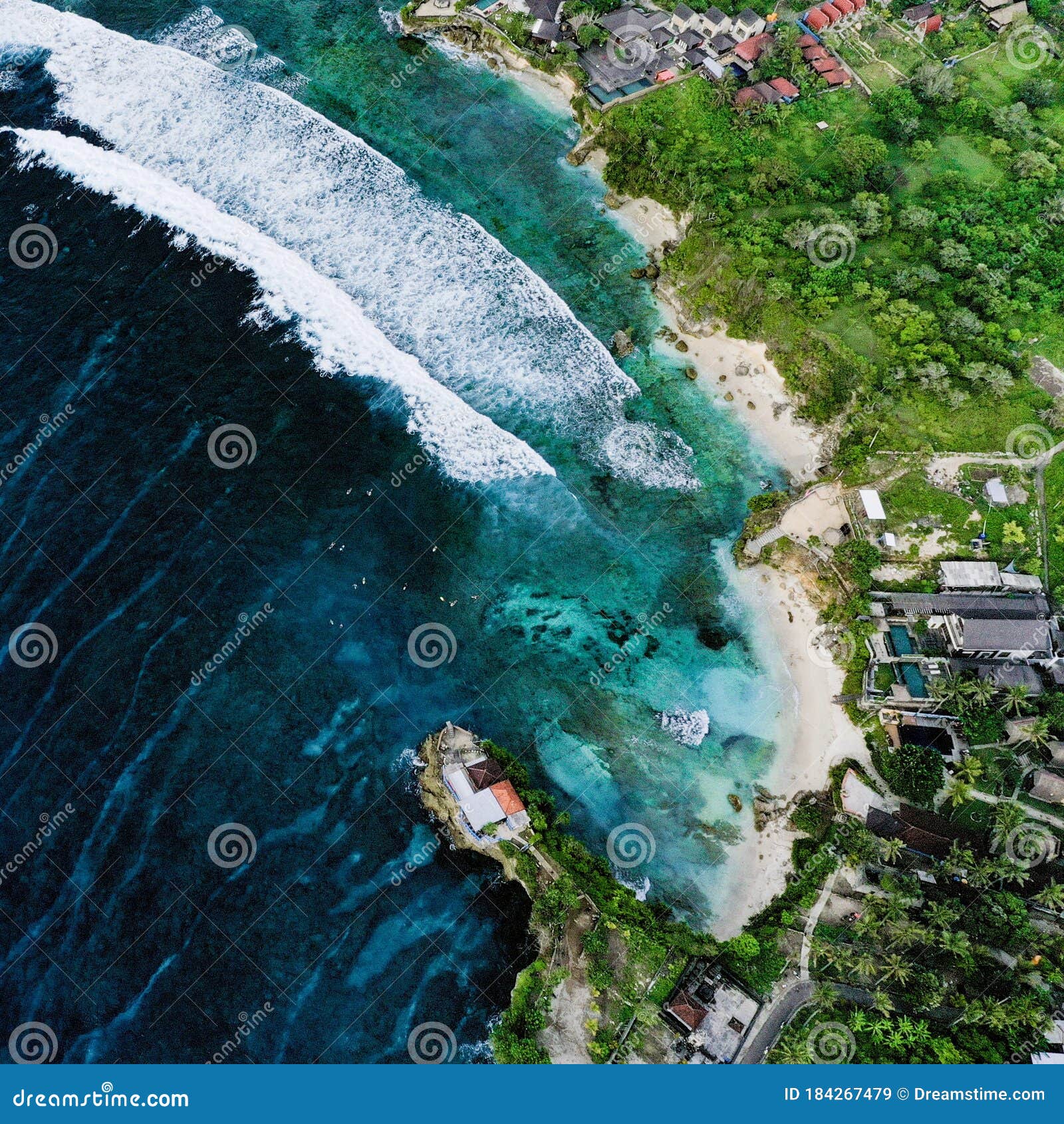 drone shot over the ocean and beach in bali, indonesia