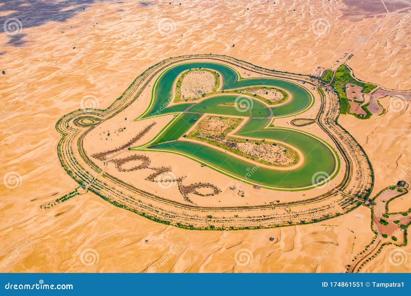aerial top view of love lake and sand desert, heart d lakes in al qudra in dubai, united arab emirates or uae.  a new tourist