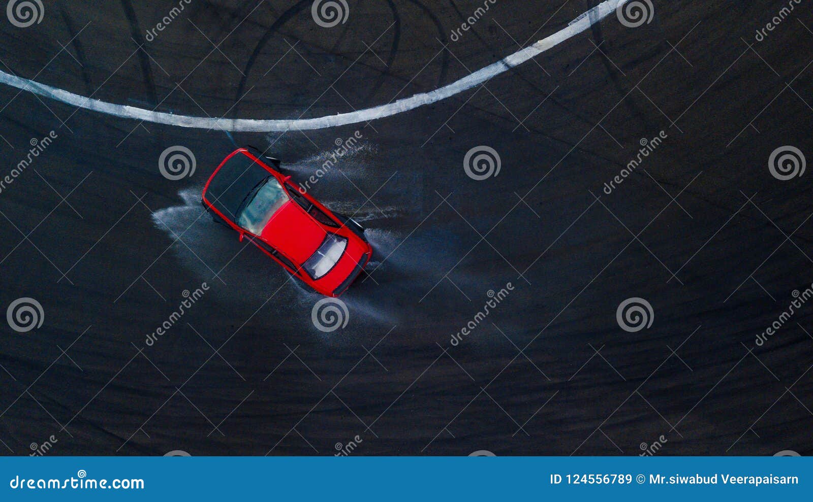 aerial top view professional driver drifting car on wet race track, with water splash, red car.