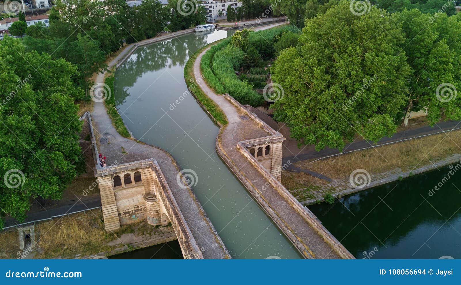 aerial top view of river, canal du midi and bridges from above, beziers town in south france
