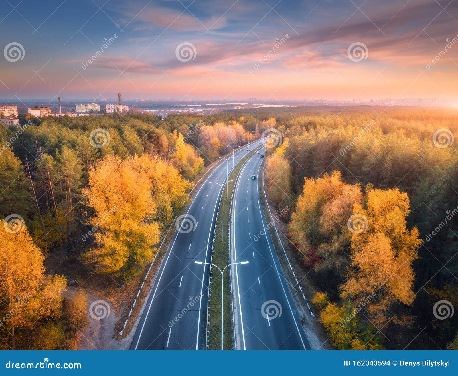 Aerial View Of Asphalt Road In Beautiful Autumn Forest At Sunset Stock
