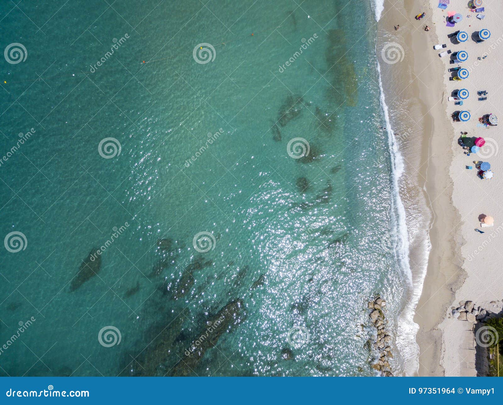 Aerial view of a beach with canoes, boats and umbrellas. Ricadi, Capo Vaticano. Calabria, Italy