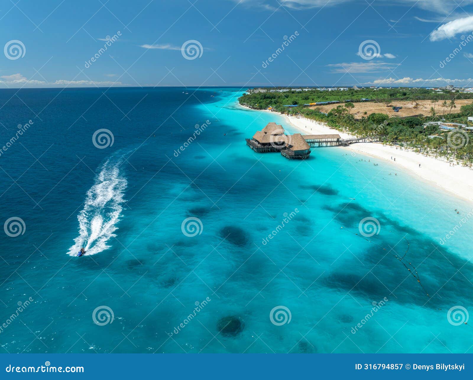 aerial view of beautiful bungalow and sea at sunset in summer