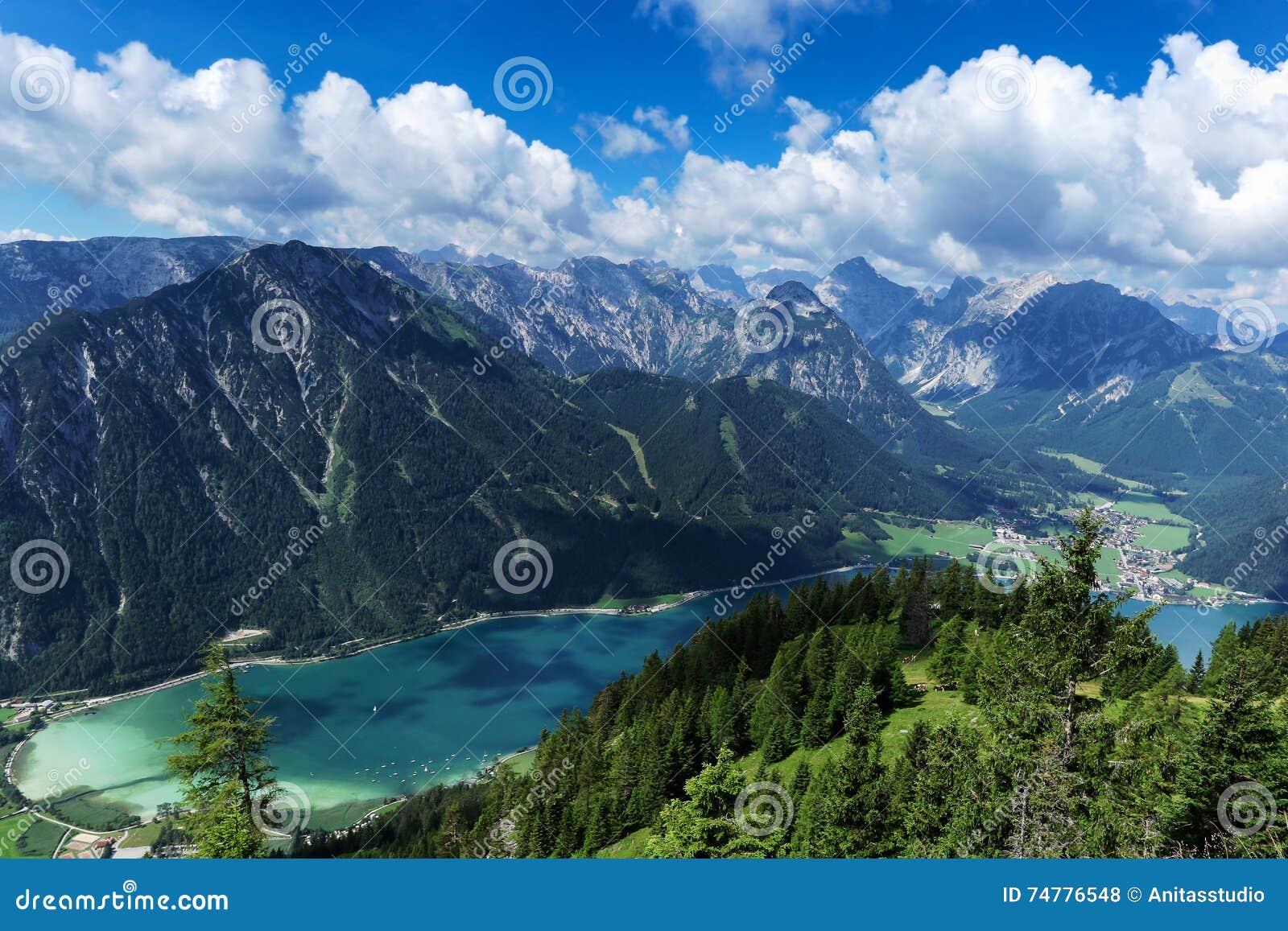 aerial view of blue mountain lake between forested rocky mountains. achensee, austria, tyrol