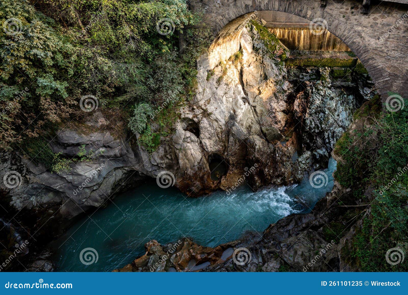 Aerial View of a Blue River Flowing Below the Bridge Surrounded by